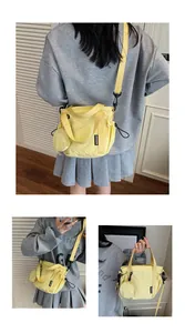 Detail of yellow nylon crossbody bag with mini round coin pouch and adjustable strap