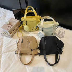 Minimalist nylon crossbody phone bags in four colors with matching round coin pouches