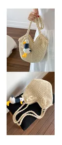 Detail of cream woven tote bag with hollow mesh pattern and cute duck charm