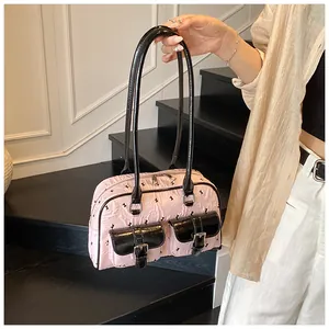 Detail showing pink lace bag with black bow rabbit print and glossy front pockets