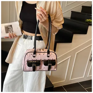 Detailed view of pink lace Boston bag featuring rabbit patterns and dual front buckle pockets