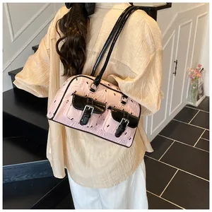 Detail of pink and black paneled underarm bag with rabbit pattern on a model