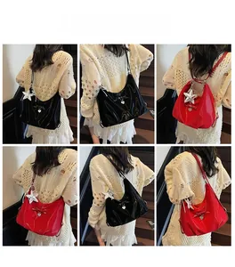 Detailed back view of model wearing black and red glossy tote bags with star charms