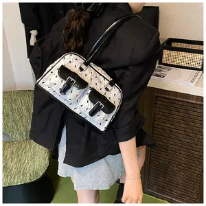 Lace bow hobo bag featuring dual front pockets and silver buckles in black and white