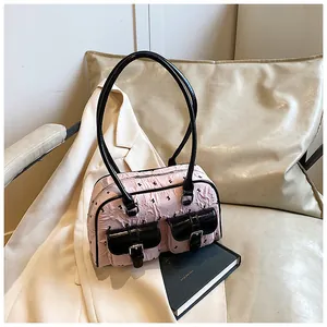 Detailed macro view of pink handbag with black rabbit prints and double front pockets