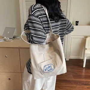 Minimalist beige canvas tote bag with today mood embroidery for daily student casual use
