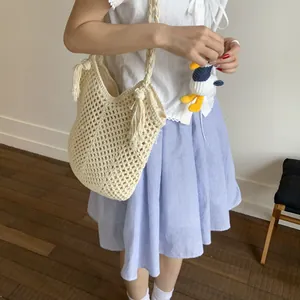 Beige oversized cotton rope woven shoulder bag with chic hollow knit and tassel details