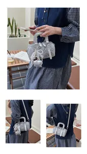 Detail of silver denim Boston bag featuring diamond texture and heart pendant charm