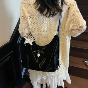 Glossy black hobo shoulder bag with bow and silver star charm pendant detail
