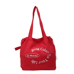 Large red canvas tote bag with white lettering and drawstring design for casual style