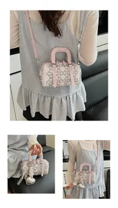 Detailed close-up of a mini white and pink Boston bag with rhinestone cannage patterns