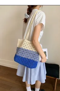 Close-up of tricolor crochet knit tote bag showing hollow weave texture and blue stripes