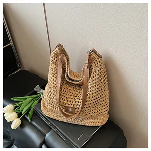 Detail of hollow knit mesh texture and brown leather strap on a summer shoulder bag