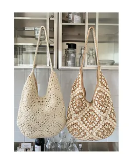 Detailed macro view of bohemian hand-woven crochet patterns on large beach tote bags