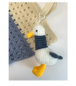 Close-up of a seagull plush charm featuring corduroy texture and a white plastic hook