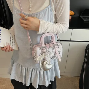 Pink and white denim Boston bag with sparkling rhinestones and heart pearl charm