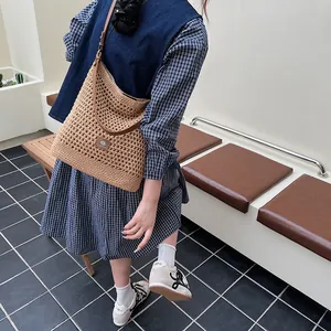 Summer hollow knit shoulder bag with brown leather strap for beach vacations