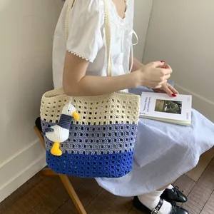 Three-color gradient knit tote bag in blue with a seagull plush toy charm for women