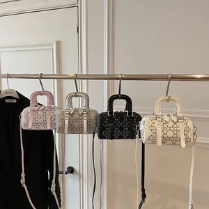 Quilted denim Boston handbags in pink, silver, black, and white with rivet details