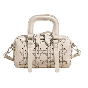 White denim Boston bag with diamond studs and top handles, crossbody style with strap