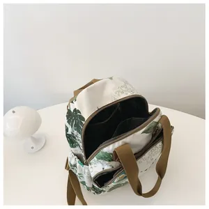 Top view showing the spacious interior and internal compartments of the floral backpack