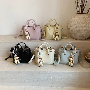 Bolso cubo moderno con textura de lichi en varios colores y colgante de muñeca