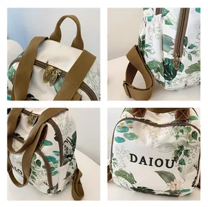 Detailed views of floral print backpack showing metal zippers and side pocket