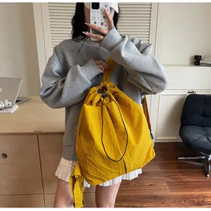 Détail d'un sac à dos jaune vif avec cordon de serrage en nylon imperméable froissé