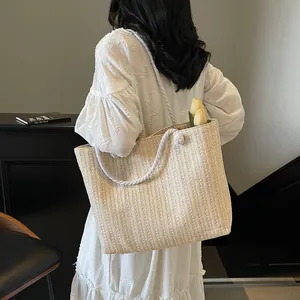 Straw woven tote bag with cotton rope handles and large capacity for beach vacation