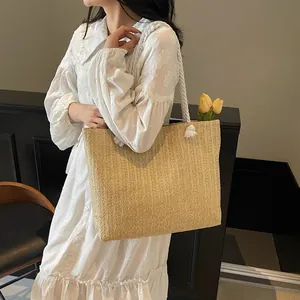 Chic straw woven tote bag with white cotton rope handles for summer beach vacation