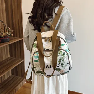Women's large capacity white floral print backpack with brown handles and straps