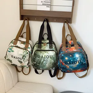 Three large capacity backpacks with floral, forest and starry sky prints and front zip pocket