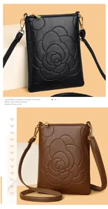 Detail of camellia embossed pattern on litchi grain leather crossbody phone bags