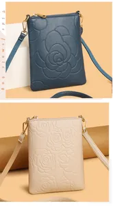 Detailed rose embossed texture on lychee grain leather mobile crossbody bags in navy and beige