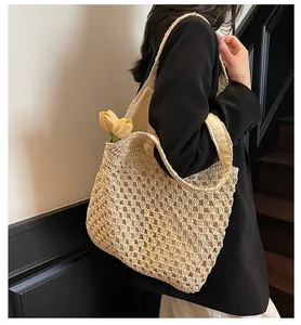 Close-up of beige hollow-out crochet tote bag with elegant tulip flowers inside