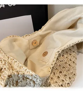 Detail of the golden magnetic clasp and woven texture on this paper rope beach bag