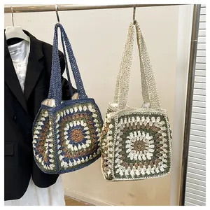 Detail of bohemian handmade crochet tote bag featuring colorful granny square patterns