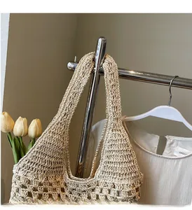 Detail shot of hand-woven beige straw tote showing intricate hollow knit patterns