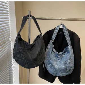 Detail of denim hobo bags showing multi-pocket patchwork and washed fabric texture