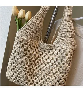 Close-up of cream woven crochet tote bag showing hollow mesh texture and craftsmanship