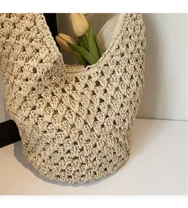 Detail of hollow paper rope weaving texture and fabric lining of this ivory tote bag