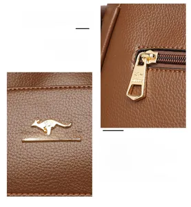 Detail of golden kangaroo logo and high-quality metal zipper on brown textured leather bag