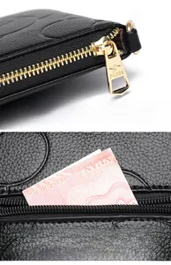 Detail of black lychee leather wallet featuring a gold kangaroo logo zipper and back pocket