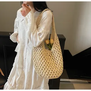 Detail view of beige paper rope woven shoulder bag with intricate crochet pattern texture