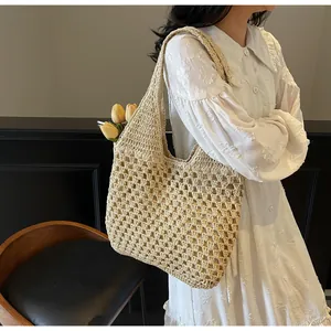 Detail of beige hand-crocheted tote bag featuring honeycomb hollow weave texture for summer