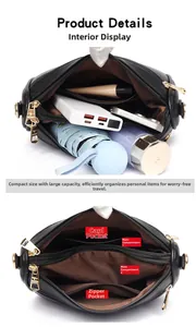 Detail view of black shoulder bag showing multiple compartments and golden zippers