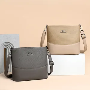 Minimalist canvas bucket bag with leather base and adjustable shoulder strap