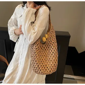 Detail view of woven hollow paper rope shoulder bag featuring natural beige texture