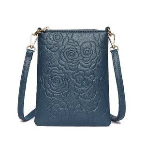 Navy blue leather cell phone crossbody bag with embossed rose pattern and gold zipper