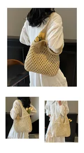Close-up of beige hand-woven tote bag with large hollow mesh patterns and cotton texture